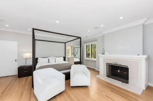 a spacious bedroom with a large bed and a couch