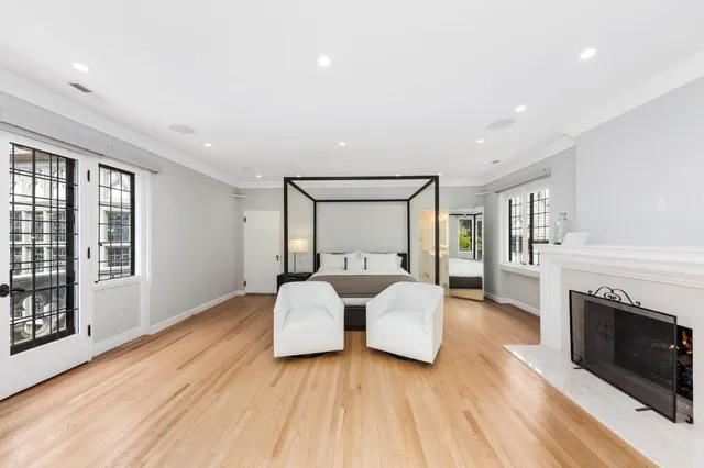 a spacious bedroom with a large bed and a couch