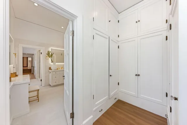 a living room with furniture a bookshelf and a large window