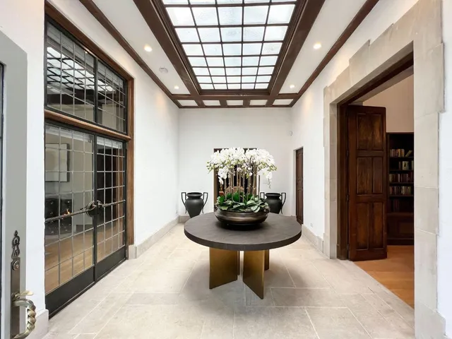 a tree in front of a white house