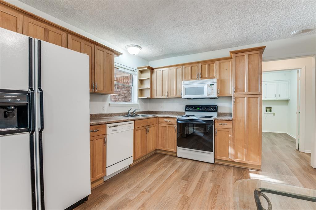 1308 Sundale Street Ennis, TX 75119 - Photo 4 of 12 a kitchen with a refrigerator stove and a sink