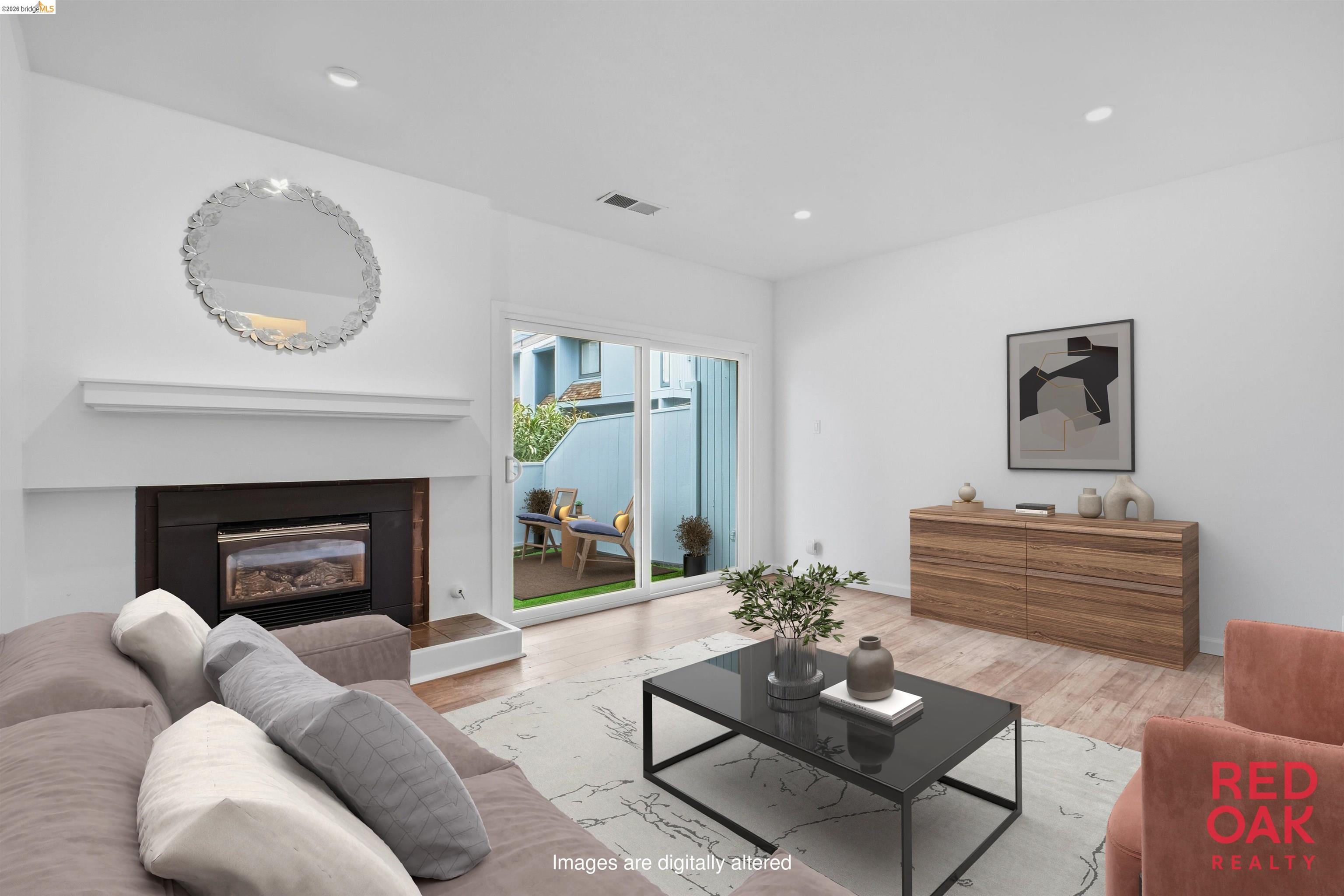 a living room with furniture a mirror and a fireplace