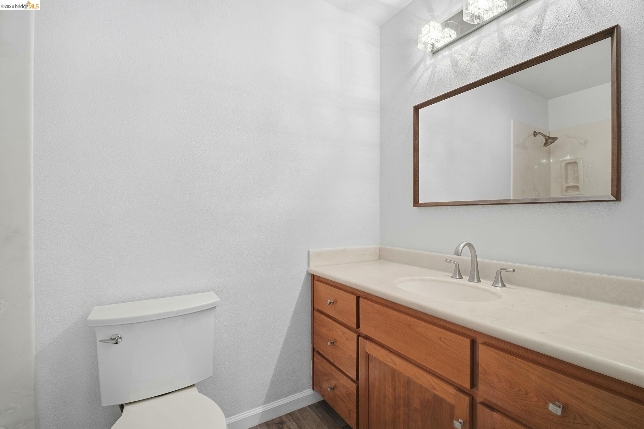 18018 Sahara Road Hayward, CA 94541 - Photo 18 of 20 a bathroom with a toilet a sink and mirror