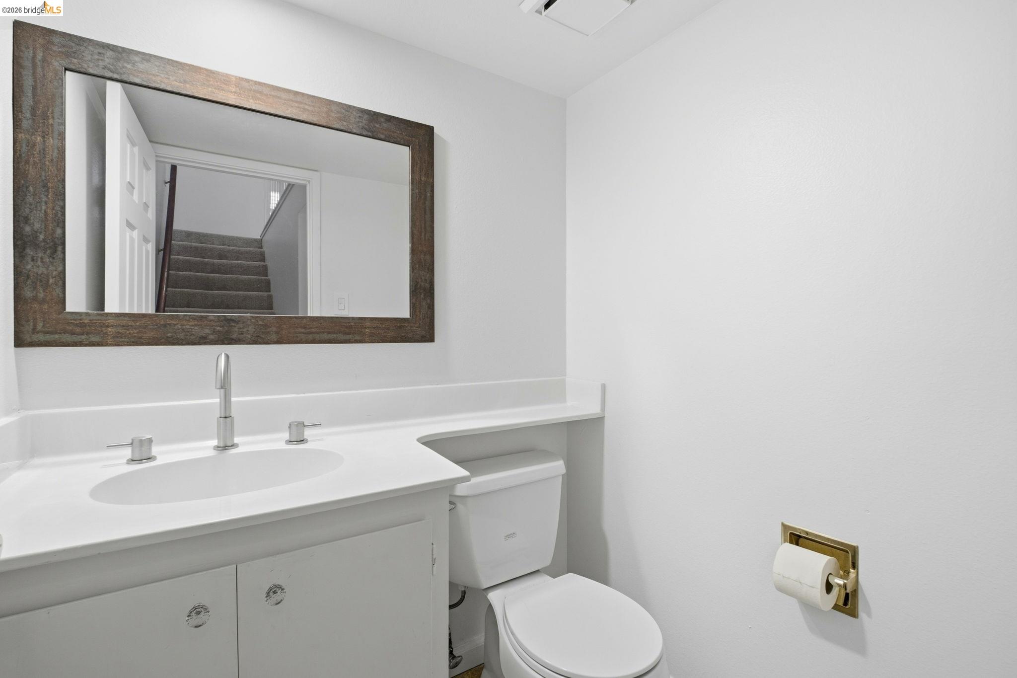 18018 Sahara Road Hayward, CA 94541 - Photo 19 of 20 a bathroom with a toilet sink and mirror