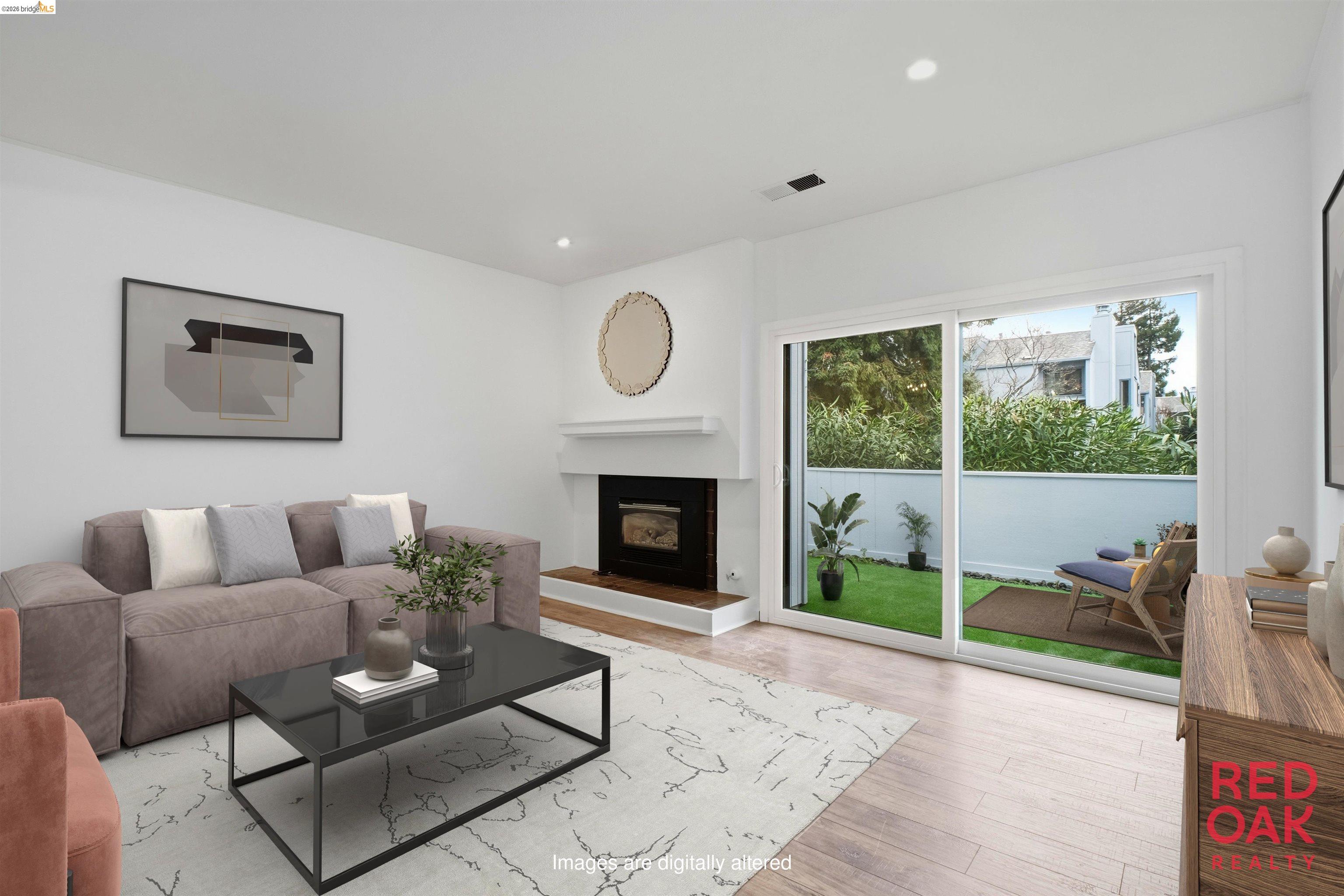 18018 Sahara Road Hayward, CA 94541 - Photo 2 of 20 a living room with furniture a large window and a fireplace