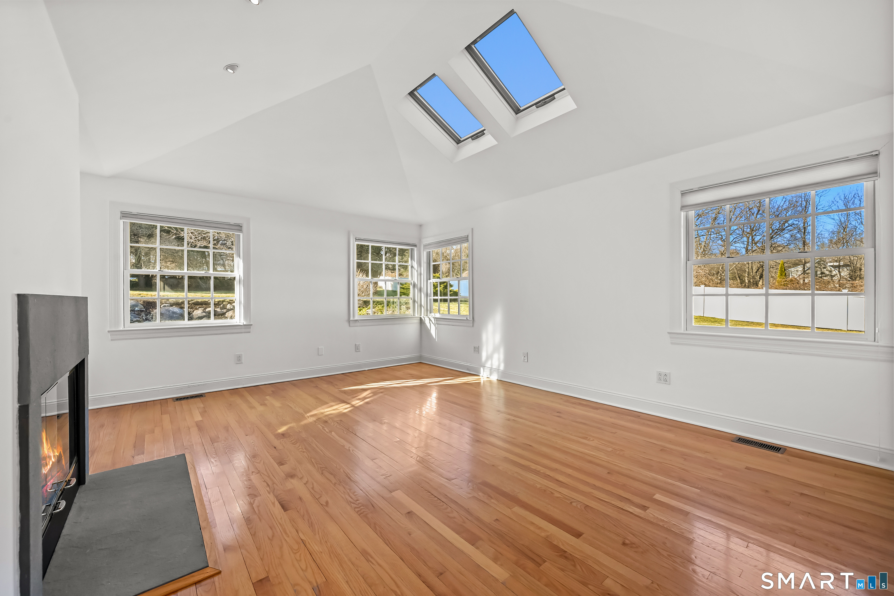 36 MacArthur Lane Stamford, CT 06902 - Photo 19 of 40 Primary Suite Bedroom with fireplace, vaulted ceiling and skylights