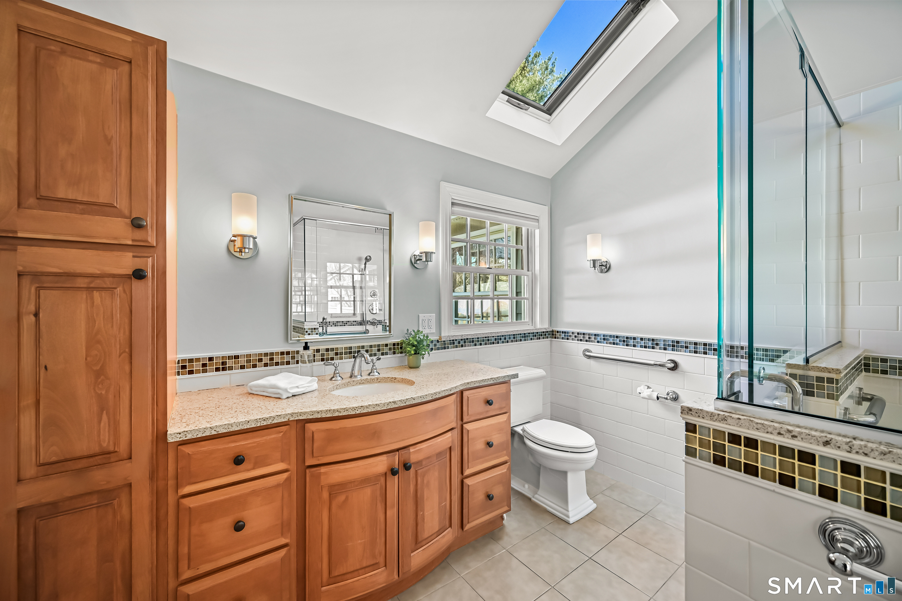36 MacArthur Lane Stamford, CT 06902 - Photo 21 of 40 Lovely Primary Bath with vaulted ceiling, skylight and double shower and lots of storage