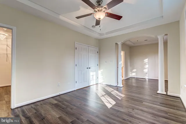 a kitchen with granite countertop a refrigerator sink and cabinets