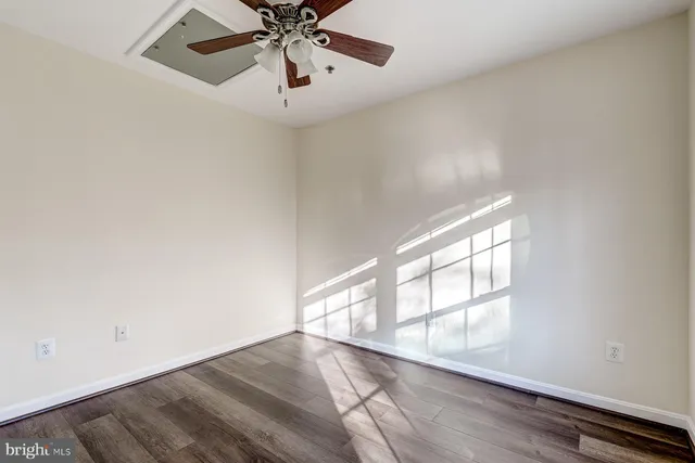 a spacious bathroom with a double vanity sink toilet mirror and bathtub