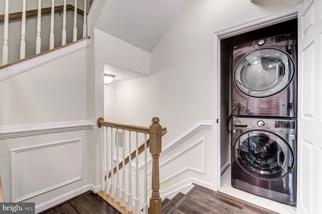 a view of front door with wooden floor and seating space