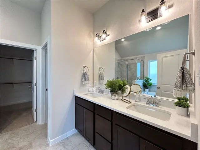 a bathroom with a sink double vanity and a mirror
