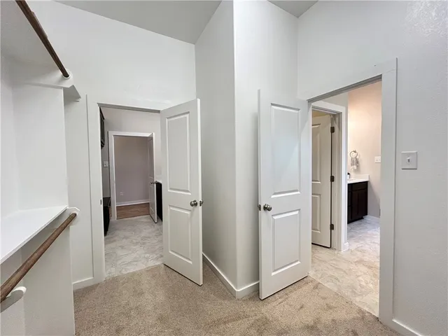 an empty room with a window and a ceiling fan