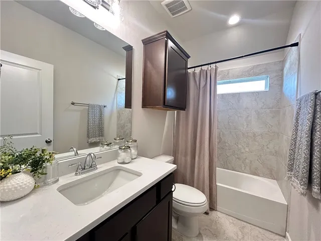 a view of hallway with cabinets and wooden floor