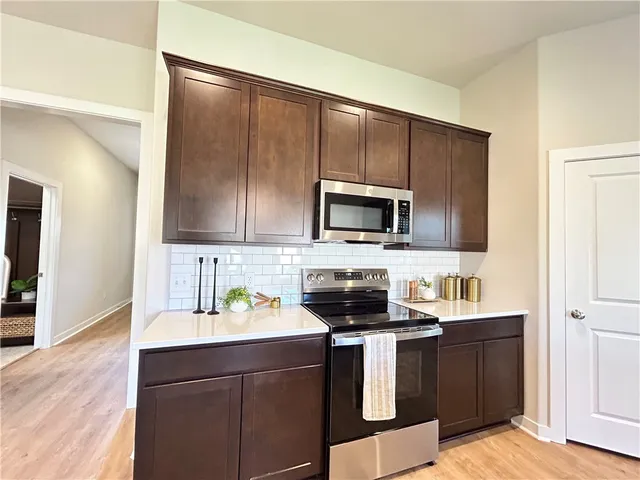 a kitchen with a sink appliances and cabinets