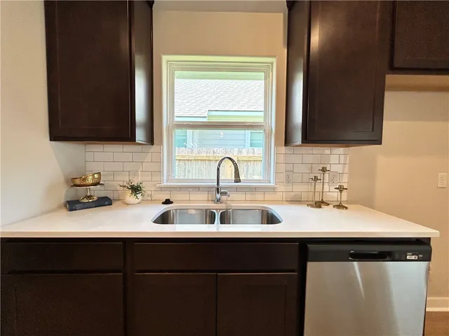 a kitchen with a sink and a window