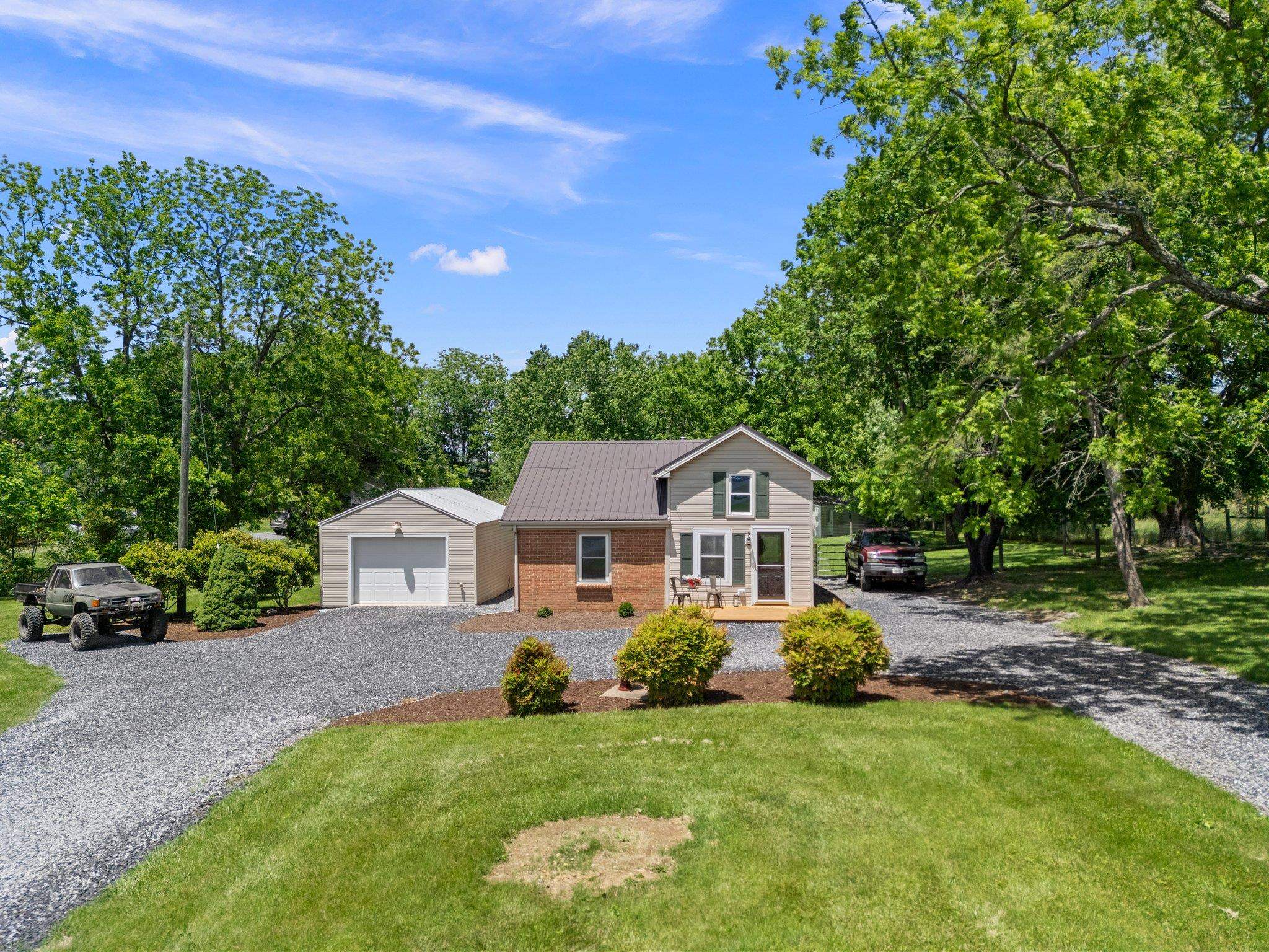 388 Kiddsville Road Fishersville, VA 22939 - Photo 5 of 50 a front view of a house with a garden and yard