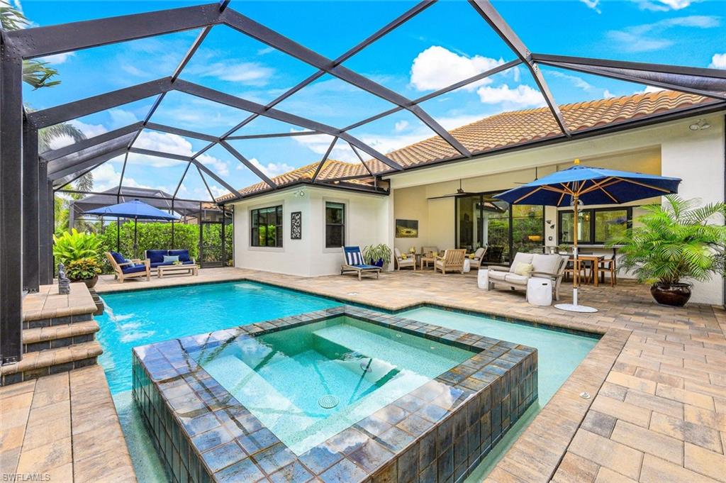 12762 Dundee Lane Naples, FL 34120 - Photo 1 of 35 a view of a patio with a table and chairs under an umbrella