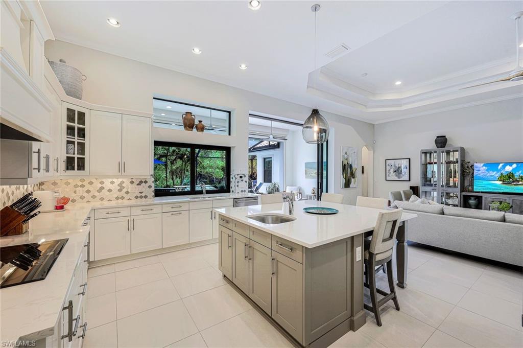 12762 Dundee Lane Naples, FL 34120 - Photo 11 of 35 a kitchen with a sink stove and cabinets