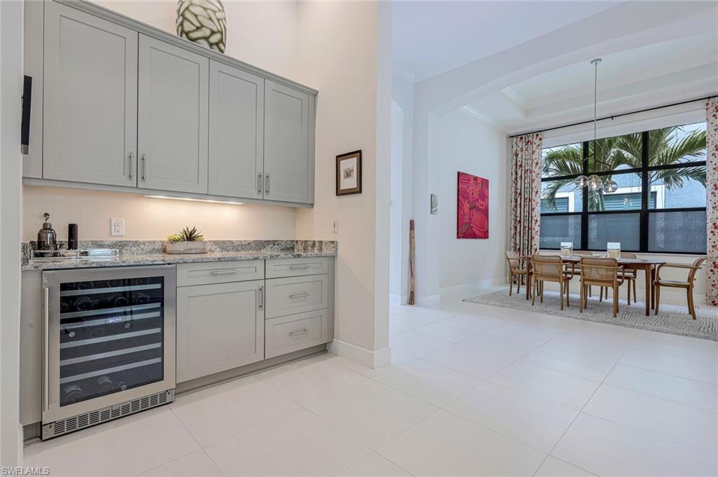 12762 Dundee Lane Naples, FL 34120 - Photo 15 of 35 a kitchen with white cabinets and sink