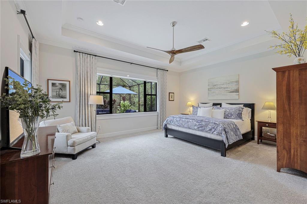 12762 Dundee Lane Naples, FL 34120 - Photo 16 of 35 a spacious bedroom with a bed couch chandelier and window