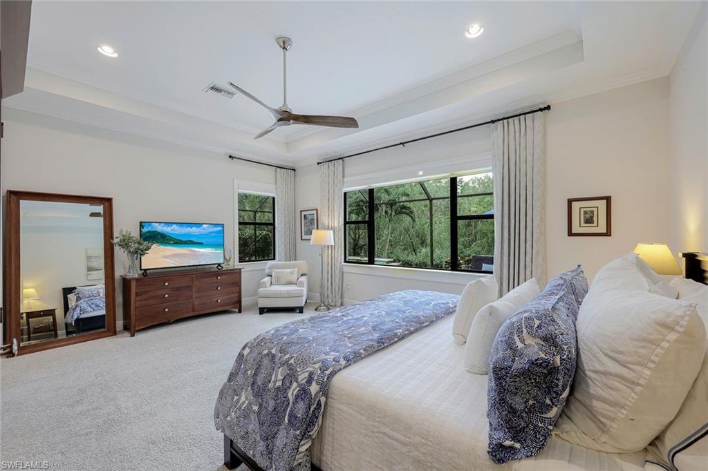12762 Dundee Lane Naples, FL 34120 - Photo 17 of 35 a bedroom with a bed a large window and furniture
