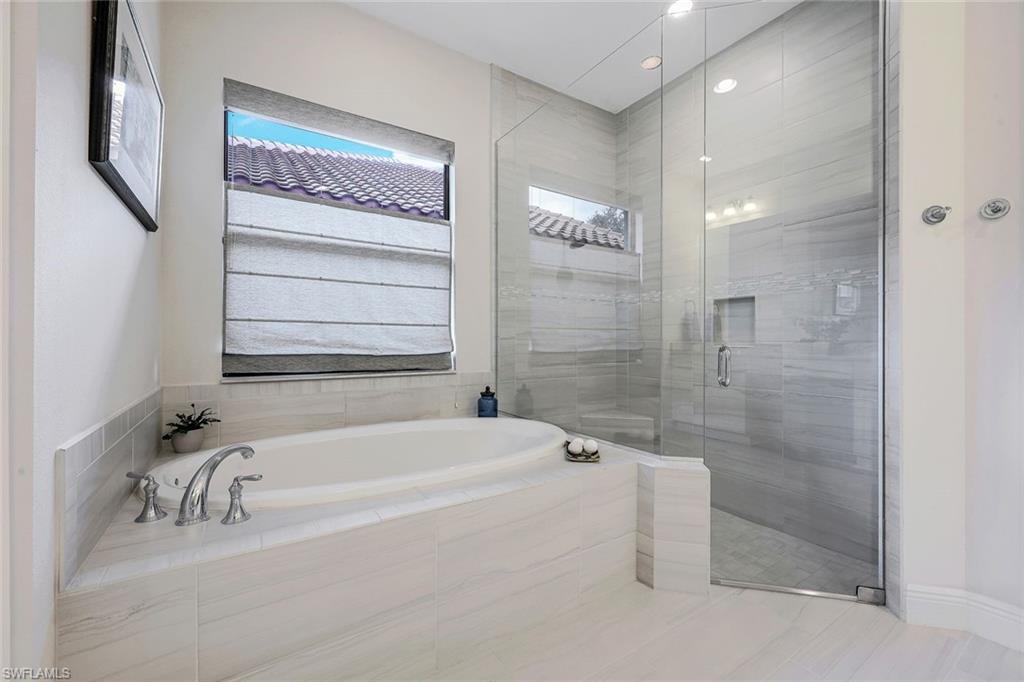 12762 Dundee Lane Naples, FL 34120 - Photo 19 of 35 a bathroom with a bathtub and a shower