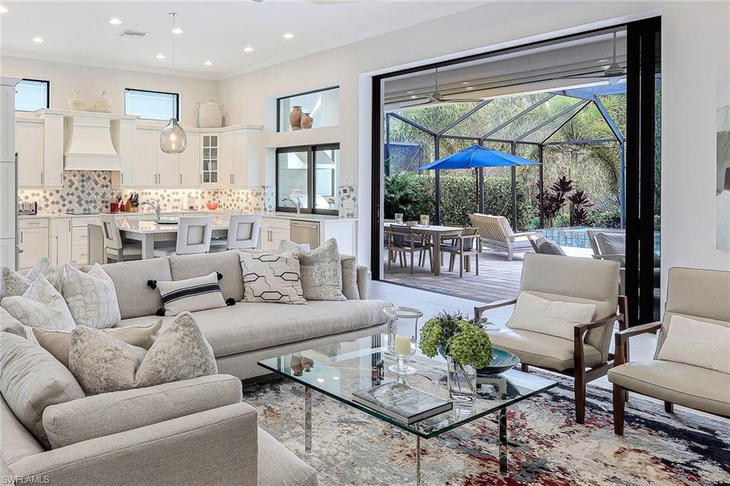 12762 Dundee Lane Naples, FL 34120 - Photo 2 of 35 a living room with furniture and a large window