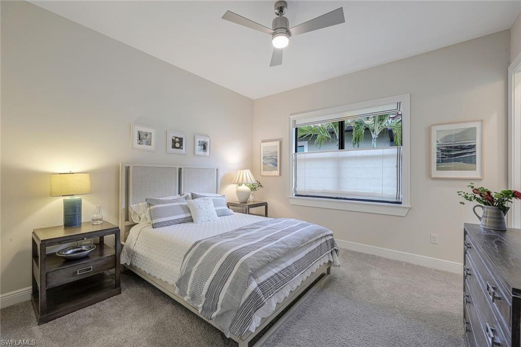 12762 Dundee Lane Naples, FL 34120 - Photo 22 of 35 a bedroom with a bed and a window