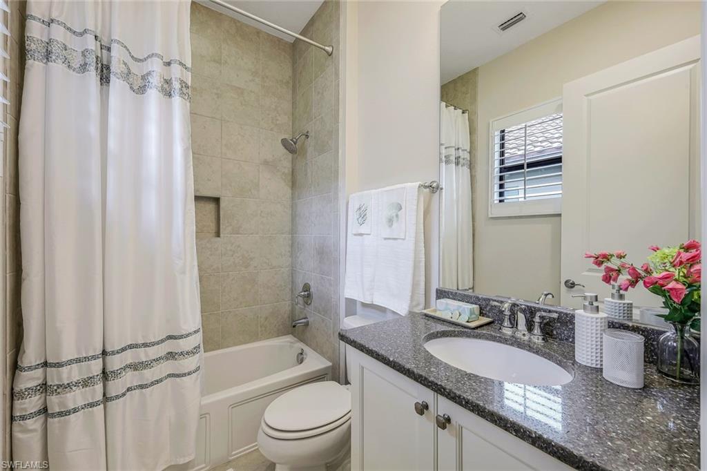 12762 Dundee Lane Naples, FL 34120 - Photo 23 of 35 a bathroom with a granite countertop sink mirror toilet and shower