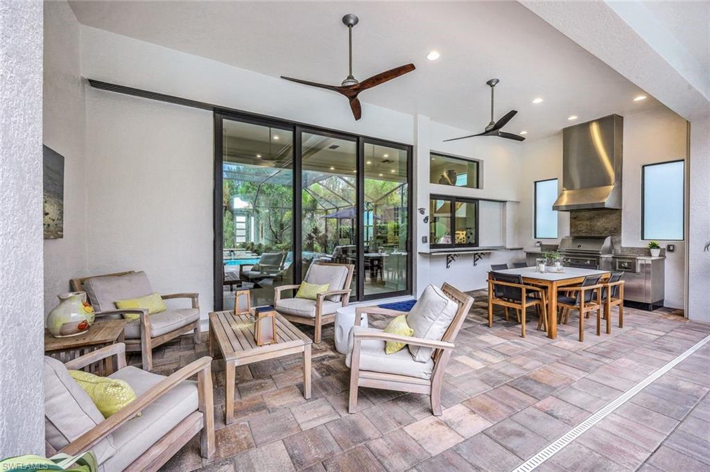 12762 Dundee Lane Naples, FL 34120 - Photo 29 of 35 a living room with furniture a large window and a table
