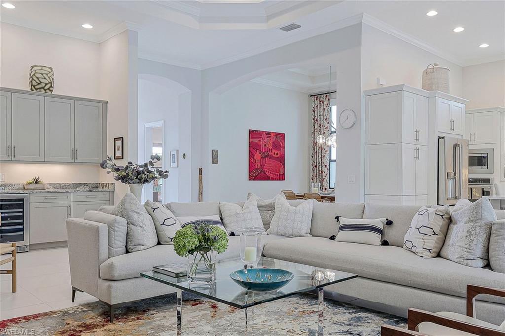 12762 Dundee Lane Naples, FL 34120 - Photo 4 of 35 a living room with furniture potted plant and kitchen view
