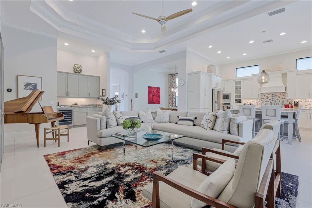 12762 Dundee Lane Naples, FL 34120 - Photo 5 of 35 a living room with lots of furniture and kitchen view