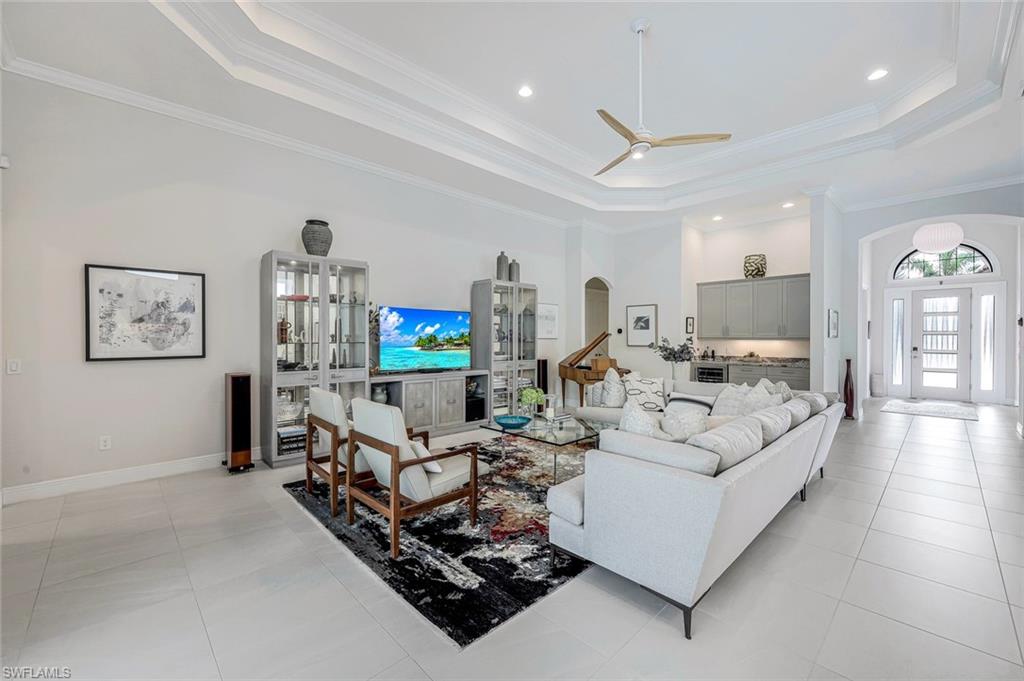 12762 Dundee Lane Naples, FL 34120 - Photo 7 of 35 a living room with furniture and a flat screen tv