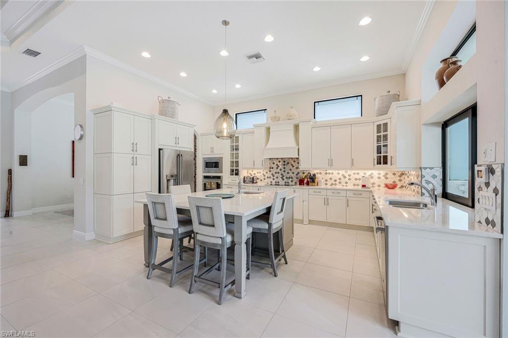 12762 Dundee Lane Naples, FL 34120 - Photo 9 of 35 a kitchen with appliances and cabinets