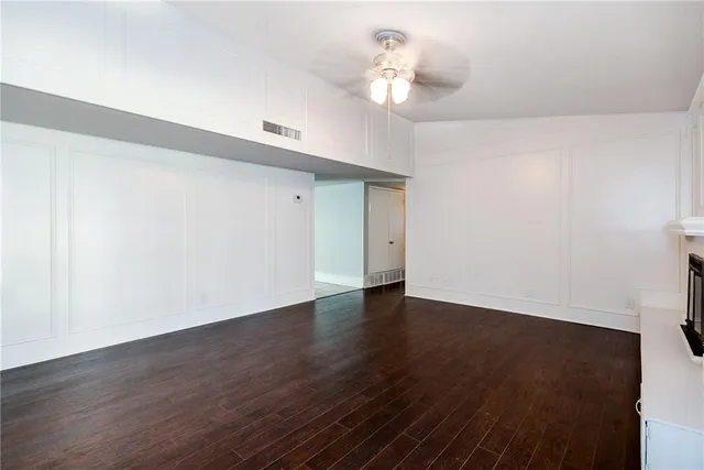 an empty room with closet and windows