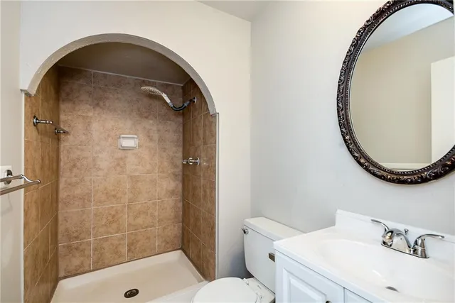 an empty room with a ceiling fan and carpet