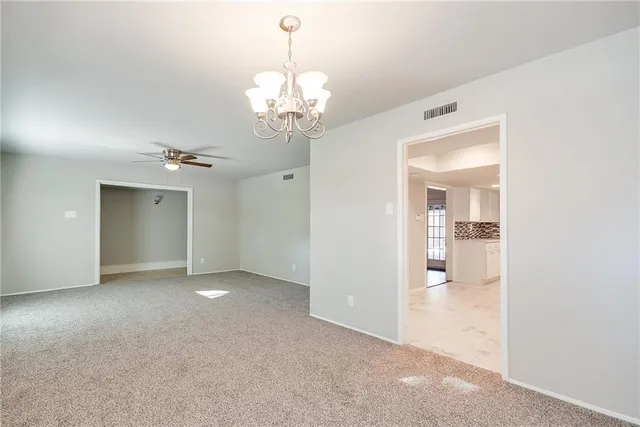 a kitchen with granite countertop white cabinets sink and stainless steel appliances