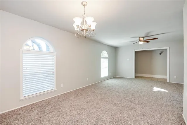 a kitchen with granite countertop white cabinets and stainless steel appliances