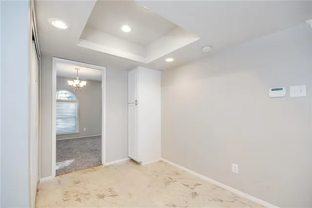 a view of a livingroom with a fireplace a ceiling fan and wooden floor