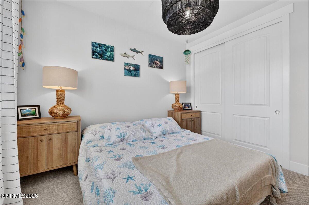 1640 Buttonwillow Street Minden, NV 89423 - Photo 29 of 39 a bedroom with a bed and a lamp on dresser