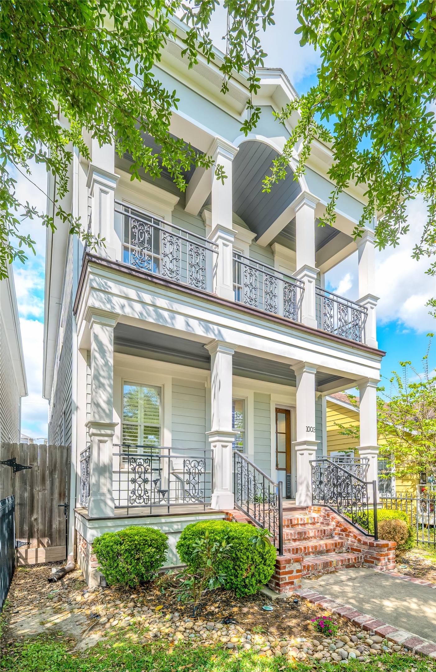 Welcome to 1003 E 25th Street! A charming New Orleans-style facade with double balconies and iron railings sets the tone in sought-after Sunset Heights.