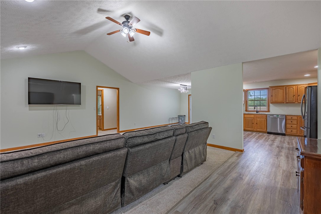 2645 Vance Road St. Paris, OH 43072 - Photo 4 of 35 This living area features vaulted ceilings and light flooring, seamlessly connecting to an open-concept kitchen.