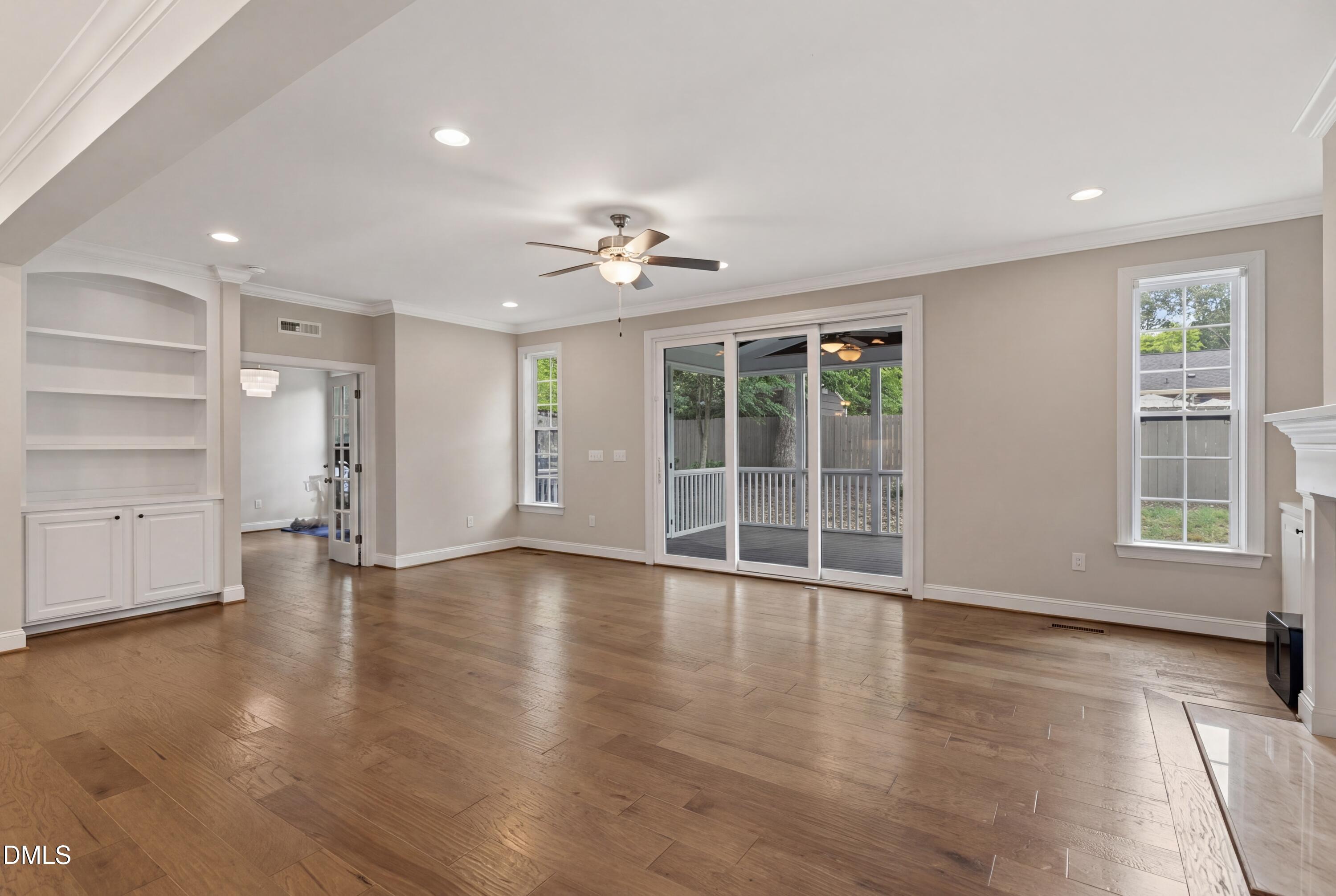 7421 Stonehenge Farm Lane Raleigh, NC 27613 - Photo 6 of 48 a view of an empty room with a window and wooden floor