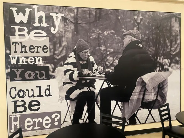 a room with pool table and windows