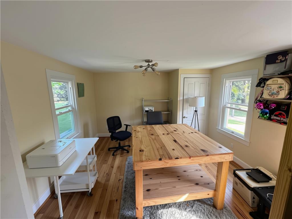 108 Effort Neola Road Effort, PA 18330 - Photo 16 of 31 Well-lit room with wood flooring, offering versatile space for a home office or creative pursuits.