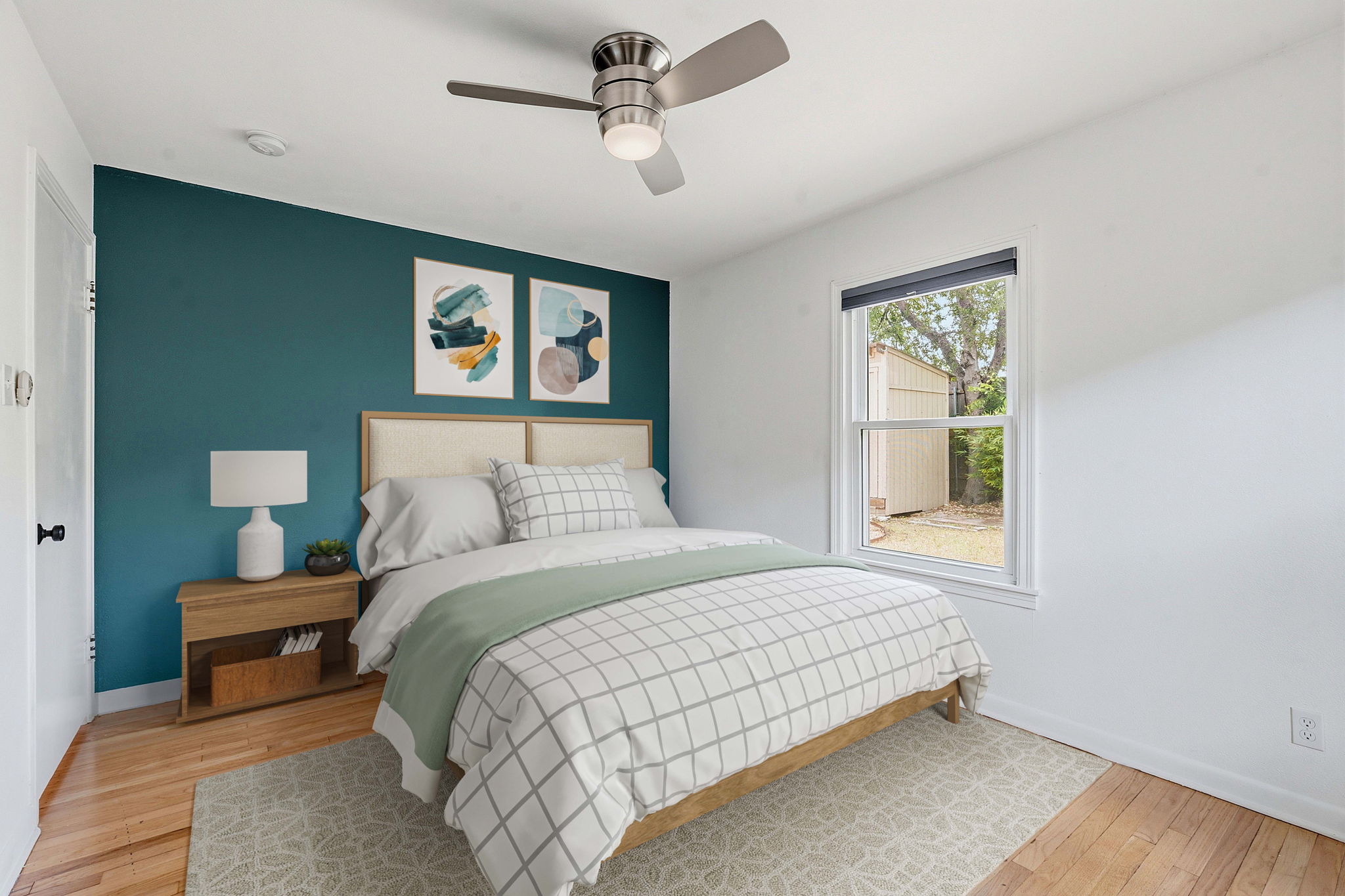 900 Stark Street Austin, TX 78756 - Photo 17 of 25 A well-lit bedroom featuring polished hardwood floors and a modern ceiling fan.