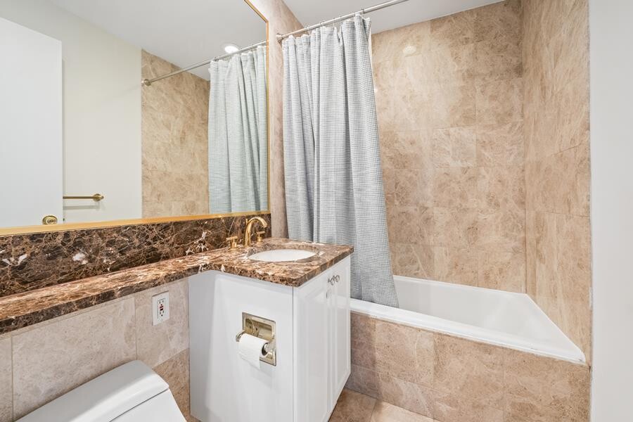 220 Riverside Boulevard, Unit 11G Manhattan, NY 10069 - Photo 6 of 7 a bathroom with a granite countertop sink and a bathtub