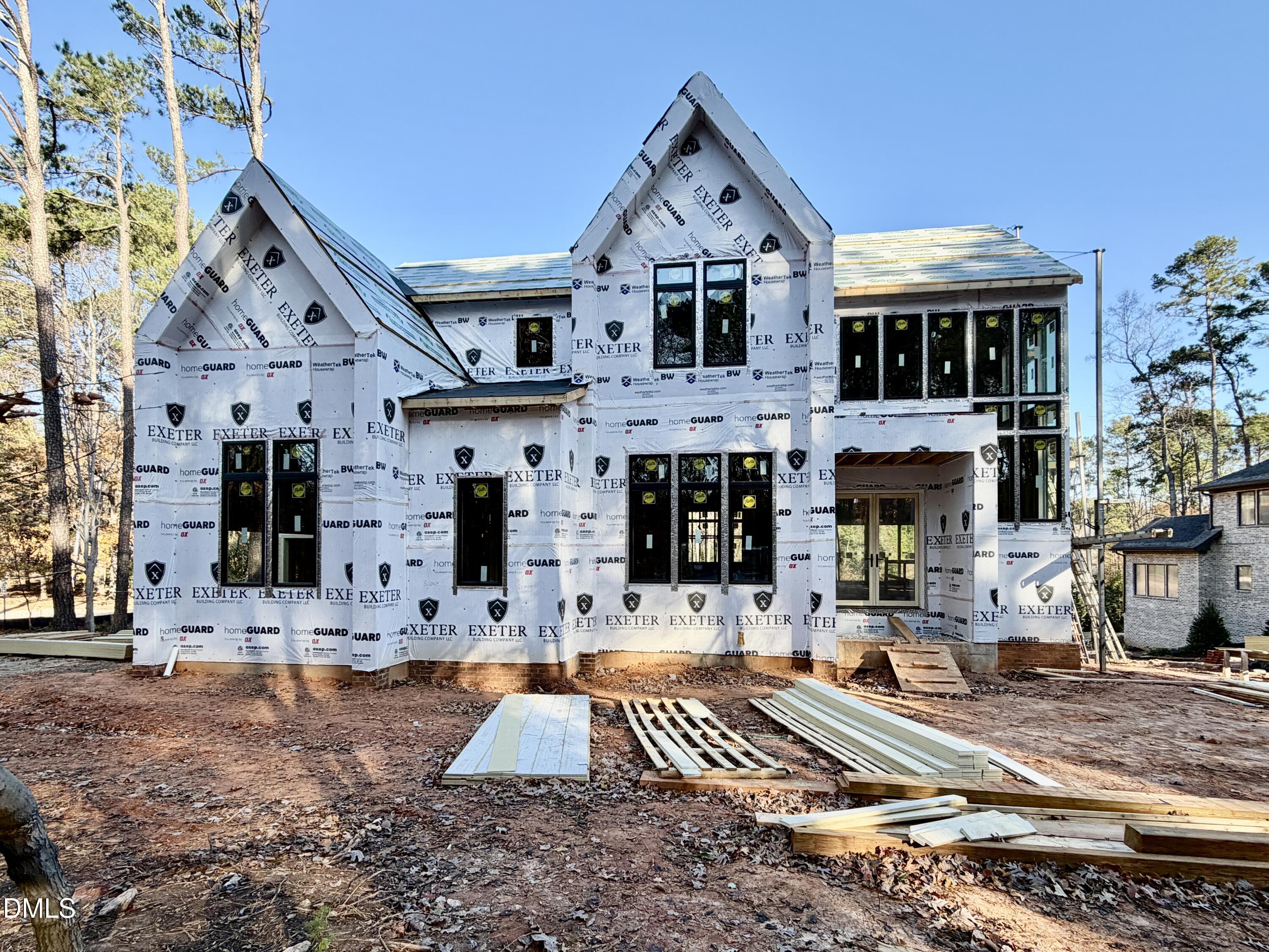 2332 Windy Woods Drive Raleigh, NC 27607 - Photo 2 of 9 a front view of a building with large trees