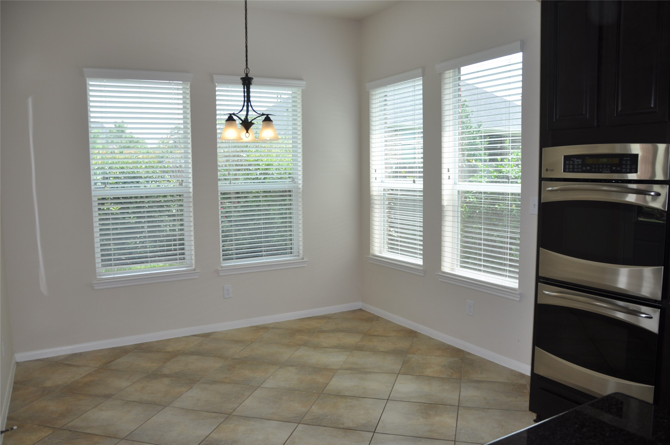 8161 Tranquil Lake Way Conroe, TX 77385 - Photo 11 of 20 a view of an empty room with a window and cabinet