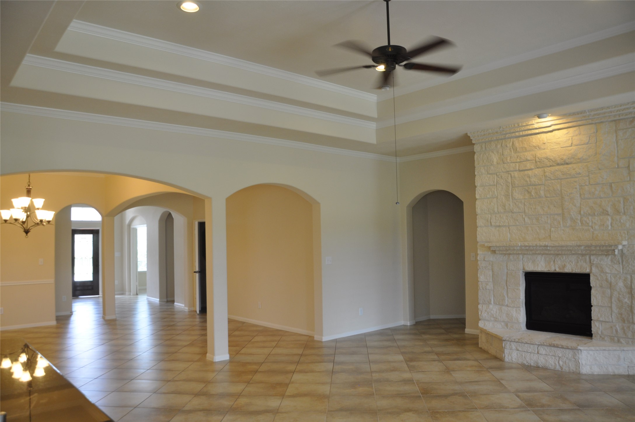 8161 Tranquil Lake Way Conroe, TX 77385 - Photo 13 of 20 a view of an empty room and chandelier fan fire place